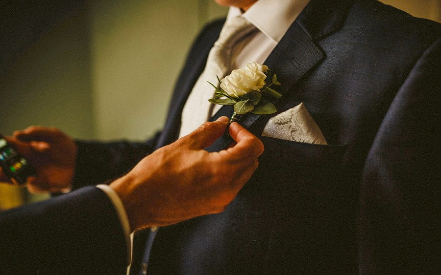 Positioning a flower on a lapel at Voewood House