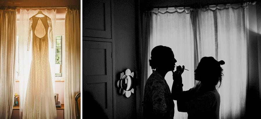 The brides dress hangs from a curtain rail next to the window of the bridal suite