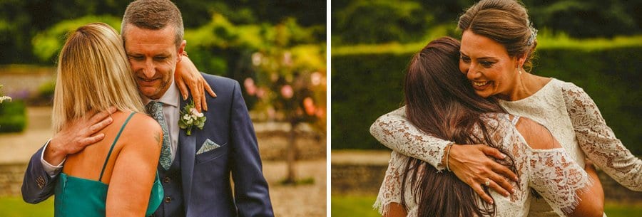 The groom and the bride embrace a wedding guest at the end of the wedding ceremony