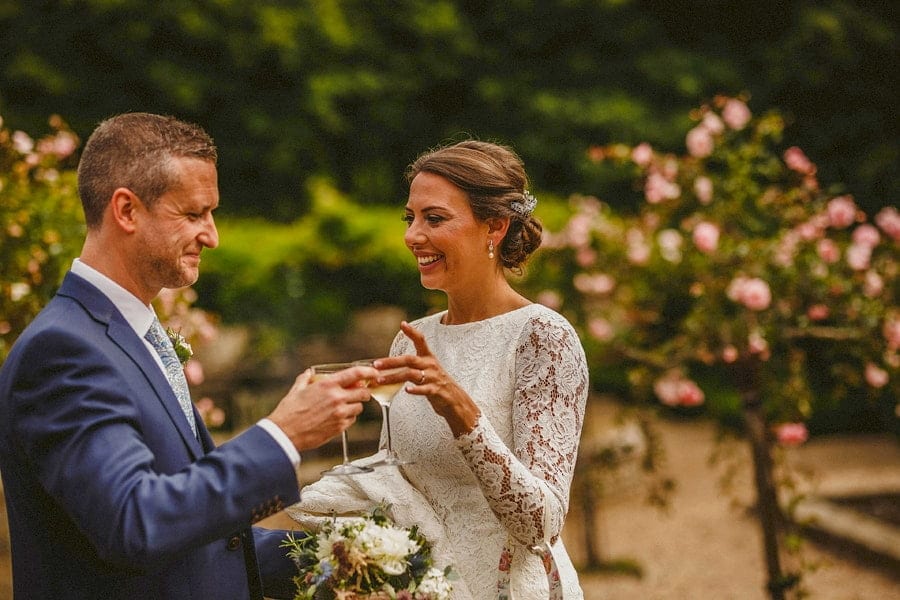The bride and groom celebrate with a glass of champagne