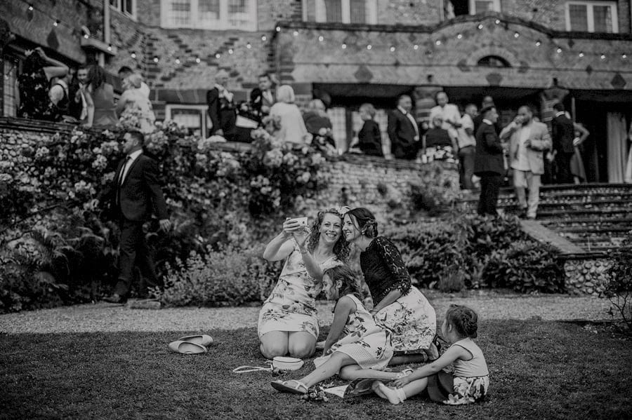 Wedding guests taking photographs of themselves on the front lawn at Voewood House