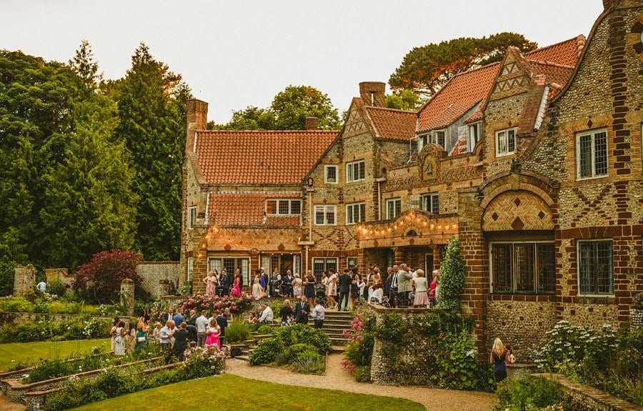 The wedding guests gather outside the house at Voewood