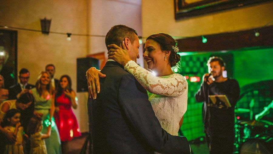The groom holds the bride in his arms on the dancefloor at Voewood House in Norfolk