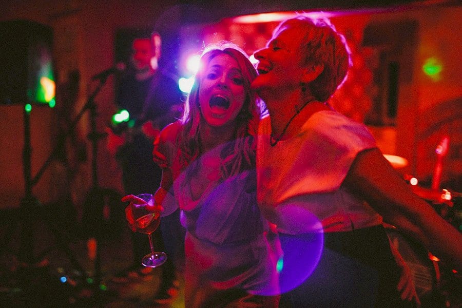 A bridesmaid and her mother dance on the dance floor at Voewood