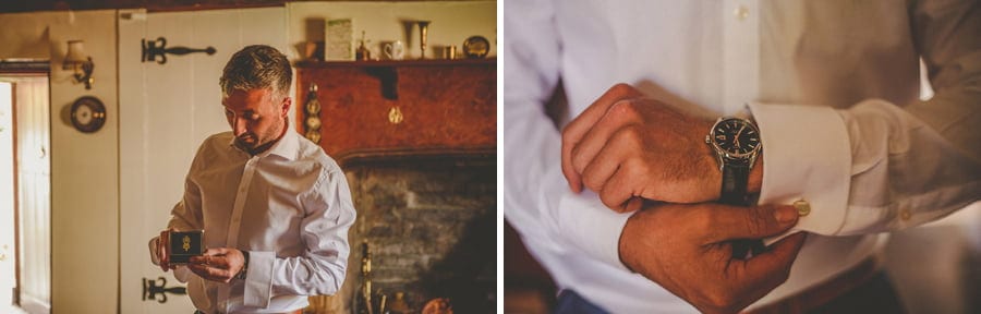 The groom fastens cuff links to his shirt sleeve