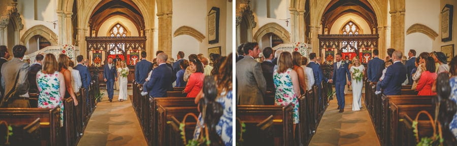 The bride and groom walk down the aisle of the church