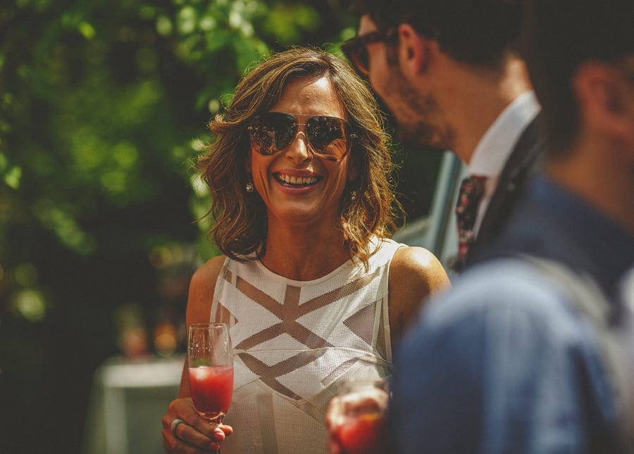 A lady laughs with her husband as she stands in the garden