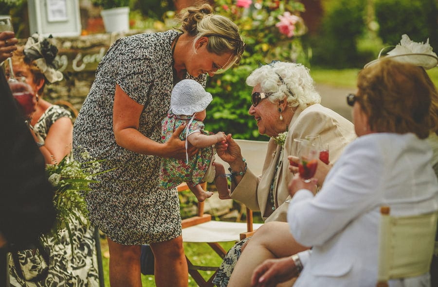 An old lady plays with her great granddaughter