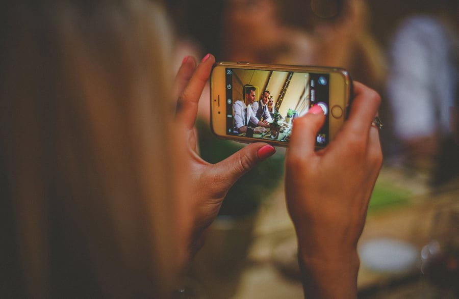 A lady takes a photograph on her mobile phone
