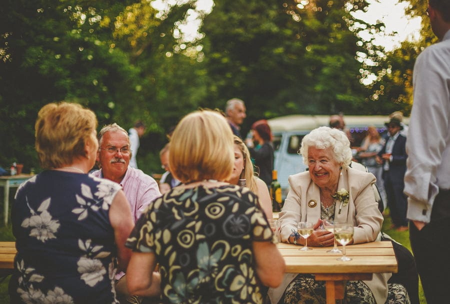 The wedding party enjoy drinks in the garden