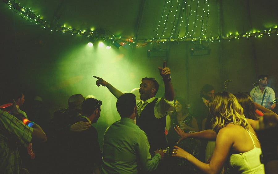 The groom dancing with his family in the tipi