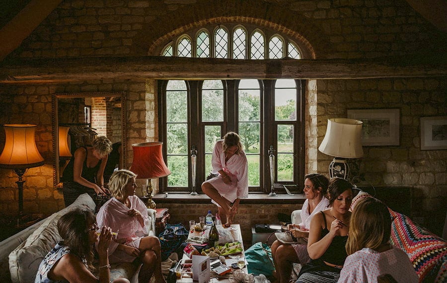 The bride and the bridesmaids get ready in the old barn at Childerley Estate in Cambridgeshire