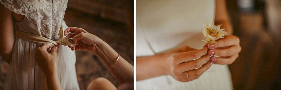 A lady ties the back of the flower girl's dress