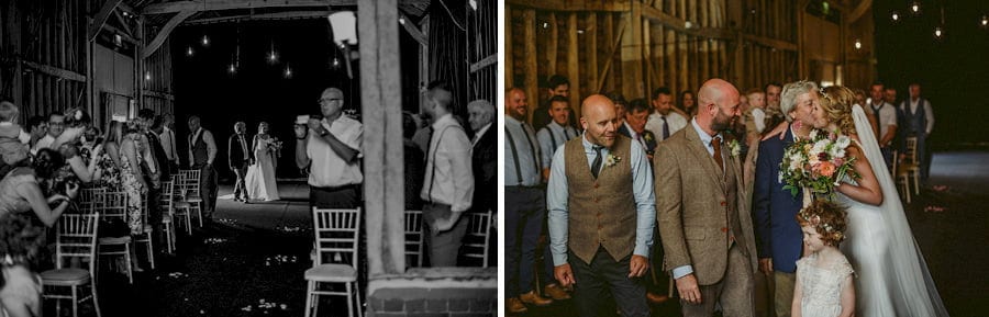The bride walks down the aisle with her father and greets the groom in the old barn