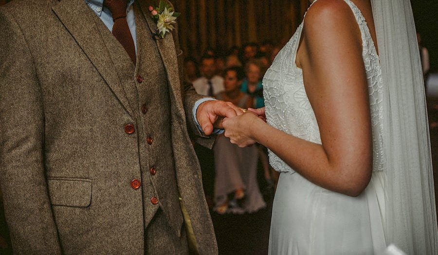 The bride holds the hand of the groom during the wedding ceremony