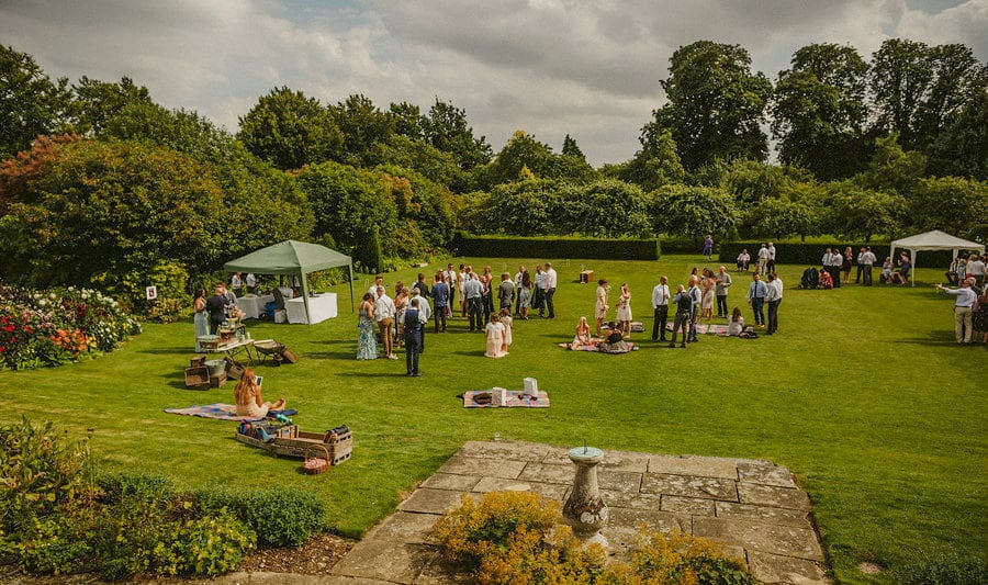 Wedding guests congregate on the back lawn at Childerley Estate