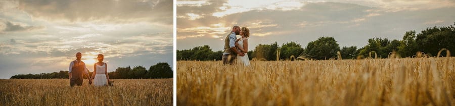The bride and groom pose for a photograph in a wheat field next to the old barn