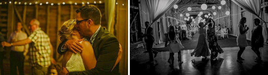 Wedding guests dancing together in the old barn at Childerley