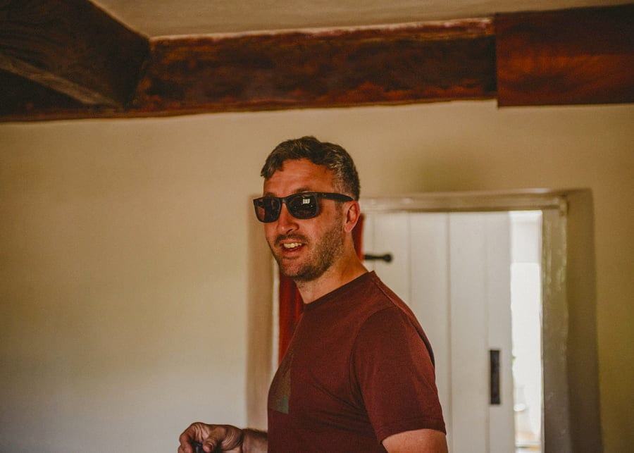 The groom smiles at his brother