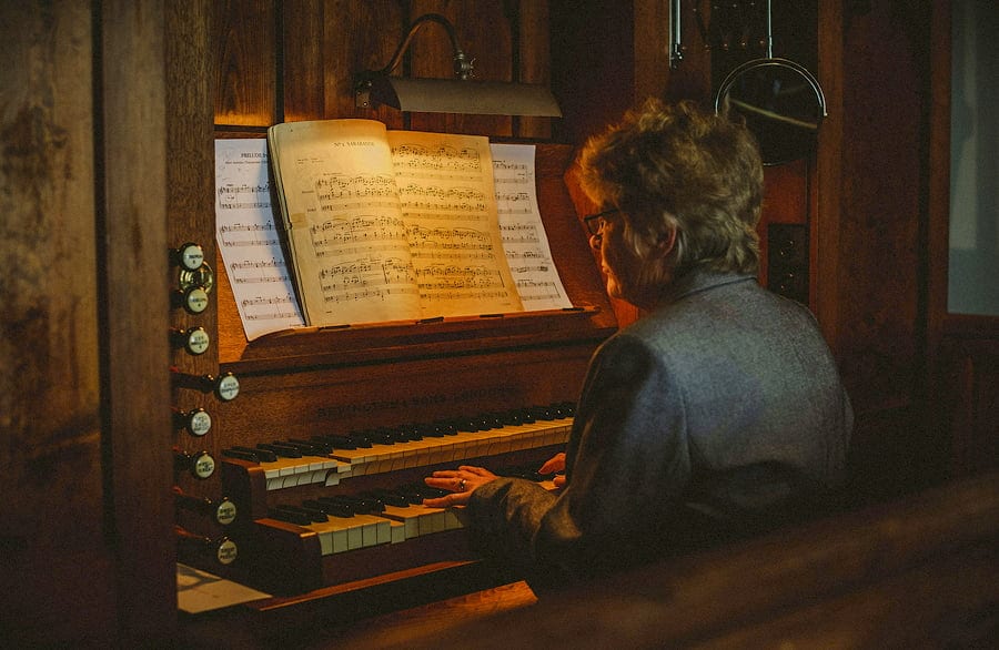 The church pianist plays on the organ