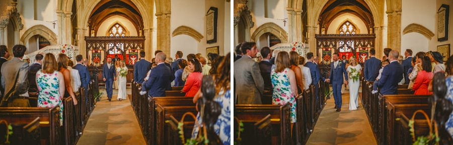 The bride and groom walk down the aisle of the church