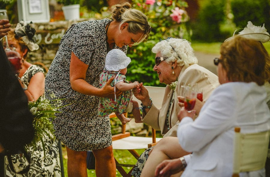 An old lady plays with her great granddaughter