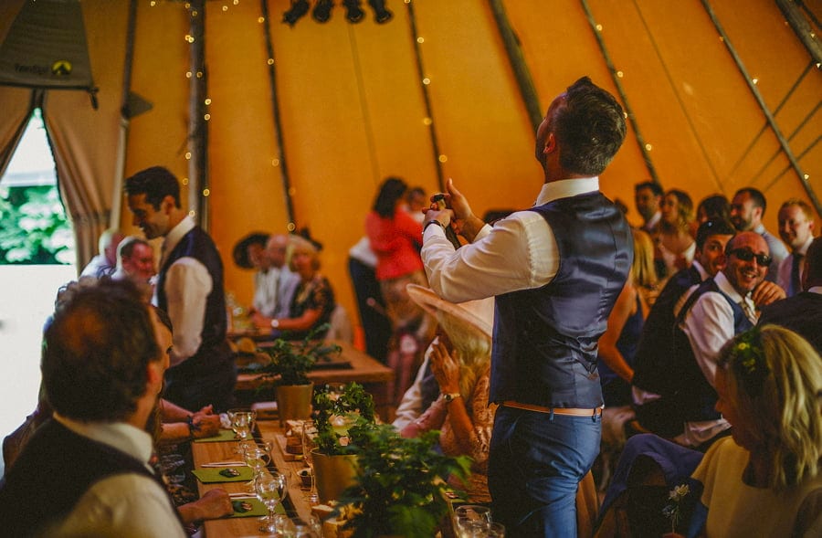 The cork explodes out of the bottle in the tipi to start the celebrations