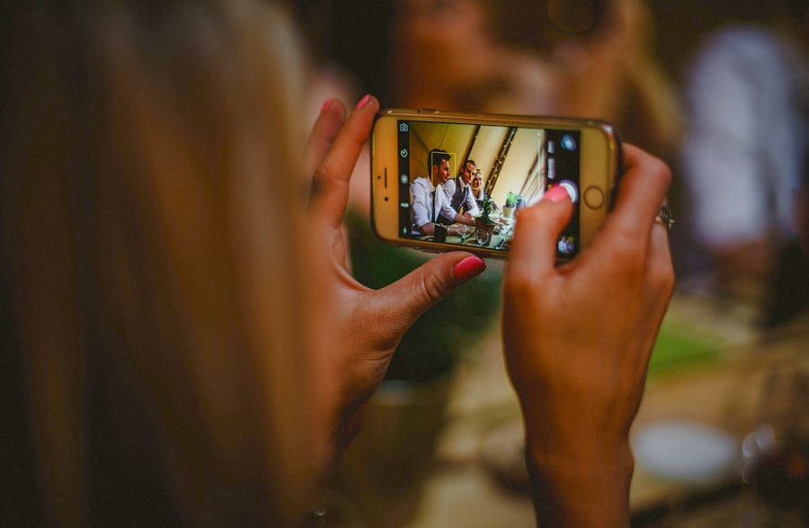 A lady takes a photograph on her mobile phone