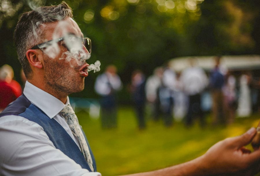 The groom enjoys a cigar