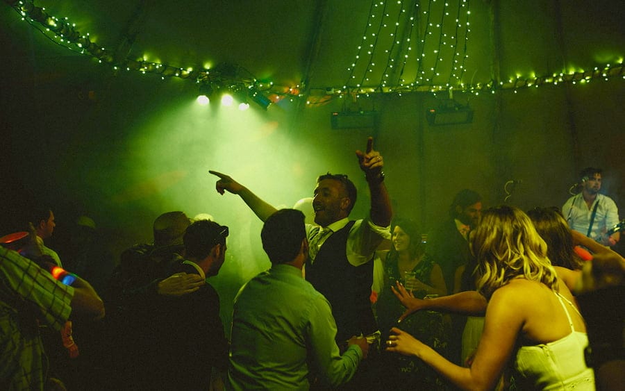 The groom dancing with his family in the tipi
