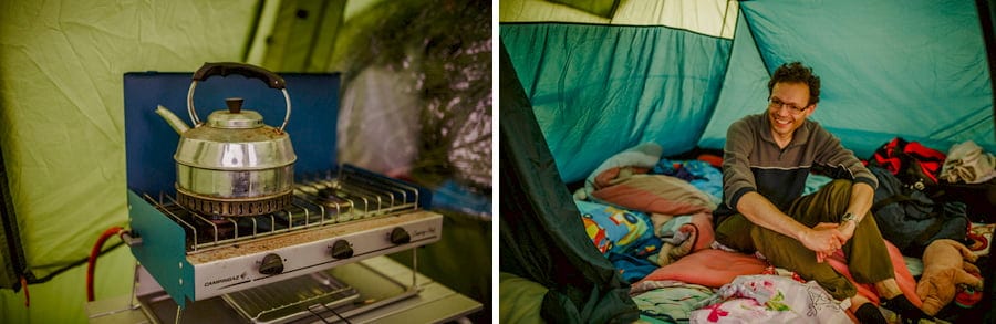A wedding guest sits on the floor in a tent and smiles