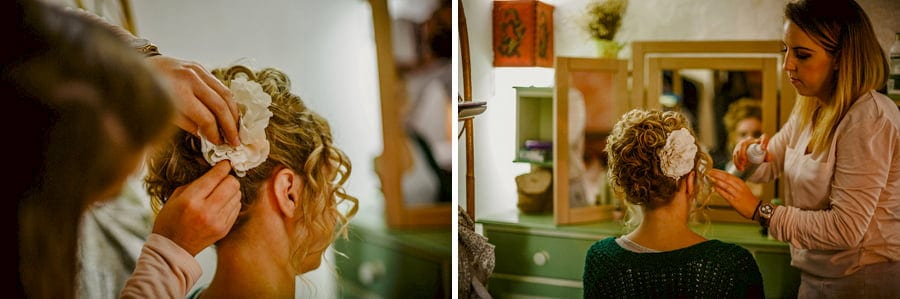 The makeup artist places a hair clip into the hair of the bride