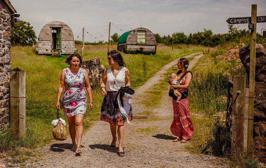 Wedding guests arrive at the outdoor ceremony at Fernhill Farm