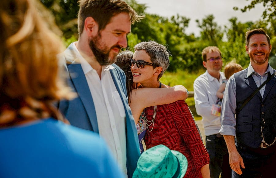 Wedding guests greet each other at Fernhill Farm