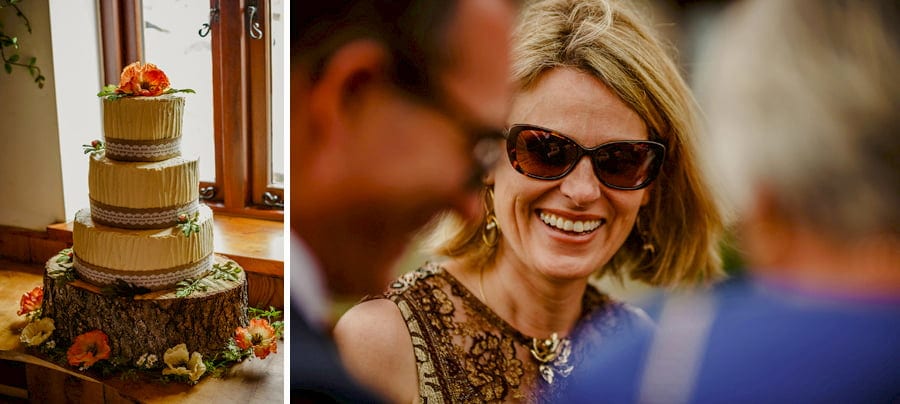 A wedding guest laughs with friends in the courtyard at Fernhill Farm
