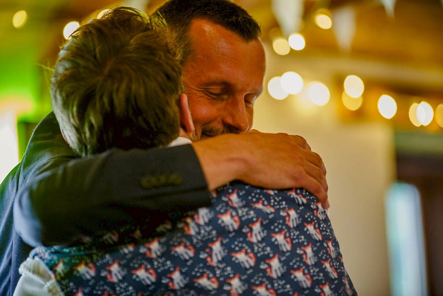 The best man hugs the groom