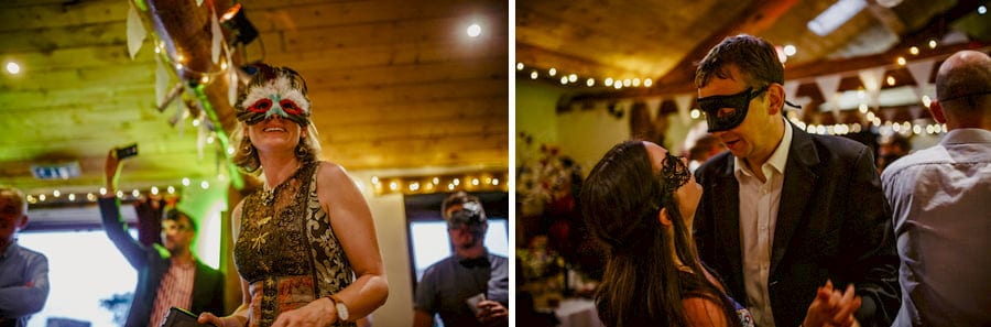 Wedding guests wearing masks dancing in the barn