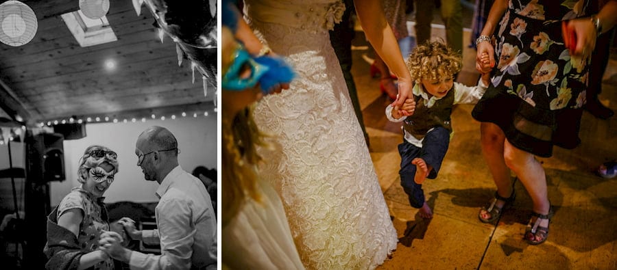 The bride and grooms son dances in the barn with his family
