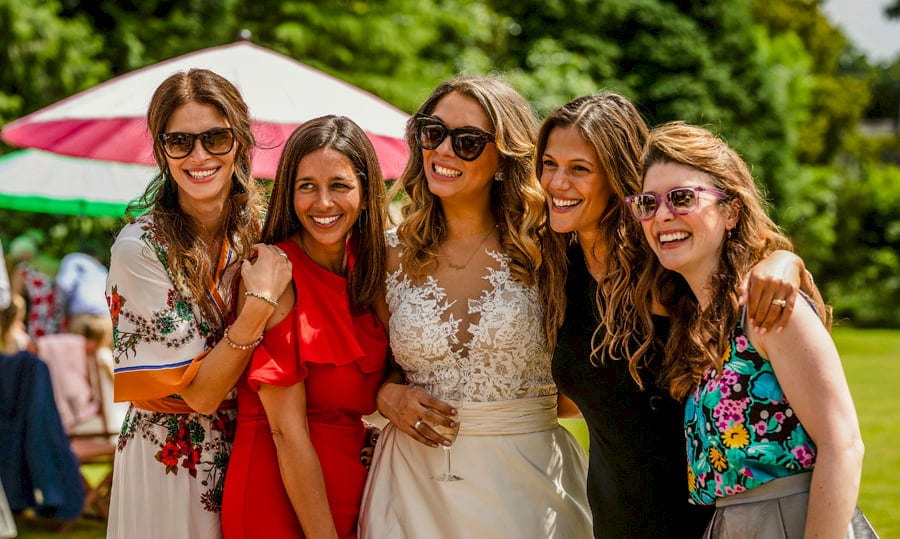 The bride and the bridesmaids on the lawn at Pennard house, Somerset
