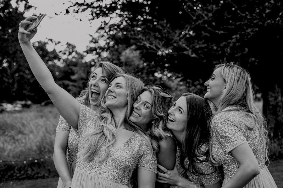 The bride and the bridesmaids taking a selfie at Pennard house, Somerset