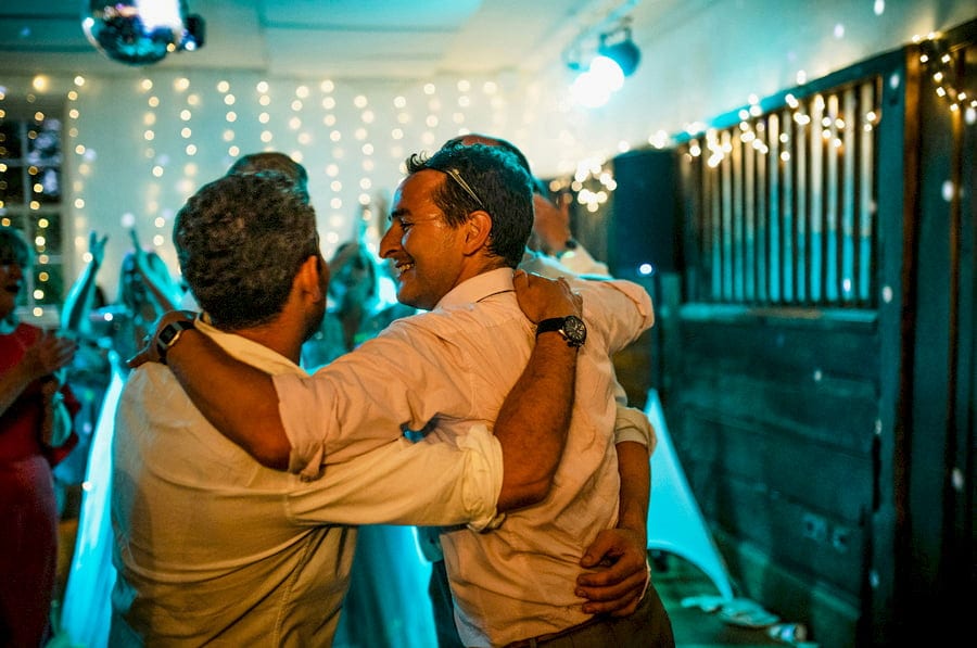 Wedding guests embrace each other during the evening celebrations