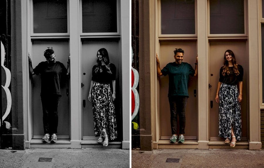 The man and lady stand and pose for a photograph inside a doorway