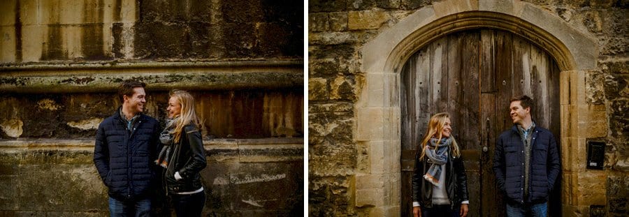 A man and lady look at each other and smile next to a wall and a doorway in Oxford