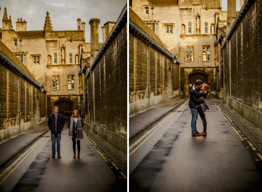 A man and lady stand in the middle of a street in Oxford and pose for a photographs